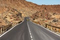 Road running through arid volcanic wasteland On Tenerife. Royalty Free Stock Photo