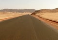 The road running through the Sahara desert.