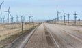 Road running Spinning wind turbines Royalty Free Stock Photo