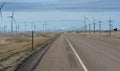 Road running Spinning wind turbines Royalty Free Stock Photo