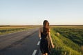 A young girl is walking along the road. Royalty Free Stock Photo