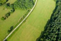 A road runs through green countryside in Europe, France, Burgundy, Nievre, towards Chateau Chinon, in summer on a sunny day