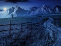 Road through rural fields in mountains at night Royalty Free Stock Photo