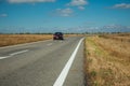 Road through rural landscape and car near the Monfrague National Park