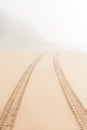 Road on sand goes to fog Royalty Free Stock Photo