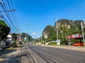 Road scene with limestone cliffs and various buildings in Krabi province