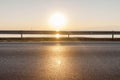 Road and sea in sunset time with burning sun Royalty Free Stock Photo