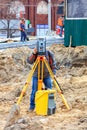 A road service engineer uses a laser level at a construction site Royalty Free Stock Photo