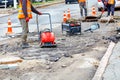 A road service team repairs sewer manholes on a section of the carriageway