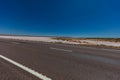 On the road side of the Stuart highway. Along the deserted barren vast landscape of the Australian outback. The grey red asphalt Royalty Free Stock Photo