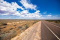 On the road side of the Stuart highway. Along the deserted barren vast landscape of the Australian outback. The grey red asphalt Royalty Free Stock Photo