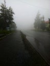 Road and sidewalk in heavy fog Royalty Free Stock Photo