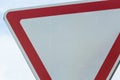 Road sign against the sky. White triangle with red border. Signal, Give way. Summer day Royalty Free Stock Photo