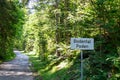 Bodental - Road sign along scenic hiking trail through idyllic forest leading to alpine paradise Bodental (Poden)