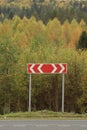 Road sign among autumn forest Royalty Free Stock Photo