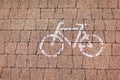 Road sign bicycle path painted in white on a cobblestone road. Concept urban environment, convenience, order, rules, sport, Royalty Free Stock Photo