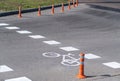 The road sign of the bike path. Drawing of bicycle with white paint on the asphalt. Marking bikeway on the pavement. Information