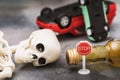 A road sign, a bottle of whiskey, a skeleton and an inverted car. Concept of drunken driving Royalty Free Stock Photo