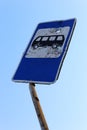 Road sign for a bus stop, at the scene of hostilities. Bullet holes in metal