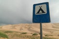 road sign camping near high dune in the gobi desert in mongolia