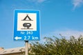 Road sign Camping Site Equipped With Power Sockets For Trailers against blue sky outdoors Royalty Free Stock Photo