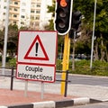 Road sign, caution and traffic light or intersection city for street safety or transportation direction, warning or Royalty Free Stock Photo