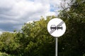 Road sign: End of no overtaking zone. Road Sign canceling of previous limitation. Round road sign with two black cars and black