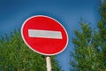 Road sign Entry prohibited on the background of tree crowns Royalty Free Stock Photo