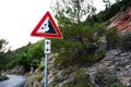 Road sign falling stones, traffic sign caution possible falling rocks