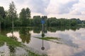 Road sign in flooded park after heavy rain Royalty Free Stock Photo