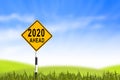 2020, Road sign in the grass field to new year and blue sky, can Royalty Free Stock Photo