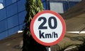 A road sign of 20 KMH twenty Kilometers per hour speed limit in the slow lane near gateway, restaurants and cafes, Prohibitory Royalty Free Stock Photo