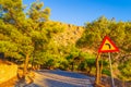 Road sign for left bend at Mesa Vouno mountain Santorini Greece Royalty Free Stock Photo