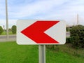 Road sign with left red arrow