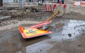 A road sign lies on a ruined city street