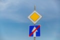 Road sign main road and one-way road end sign on blue sky background Royalty Free Stock Photo