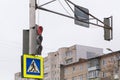 A road sign means a pedestrian crossing, a red traffic light for cars is on. Royalty Free Stock Photo