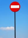 Road sign on a metal pole `Do not enter` sign against a blue sky with white clouds background. Royalty Free Stock Photo