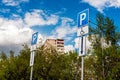 Road sign Parking space for the disabled in a residential area against the background of the sky and green trees. Capital letter P Royalty Free Stock Photo