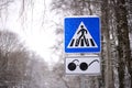 Road sign - Pedestrian crossing. Square blue and white metal plate with white stripes and a walking man. Royalty Free Stock Photo