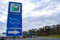 Road sign, pointed out to power station, with usual kinds of fuel and electric vehicle charging station EV, on blue background Royalty Free Stock Photo