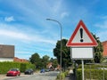 Road sign with red exclamation mark warning for dangerous situation in street on city. Blank white frame with copy space Royalty Free Stock Photo