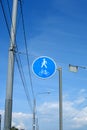 Road sign with reflective coating pedestrian and Bicycle path, against the background of blue sky and wires Royalty Free Stock Photo