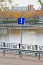 Road sign `Reverse movement` stands by the reservoir in the park