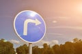 Road sign showing right turn against blue sky Royalty Free Stock Photo