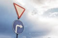 road sign sign attention and right turn on the background of dramatic sky and clouds Royalty Free Stock Photo