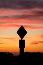 Road sign silhouette and colorful sunset Royalty Free Stock Photo
