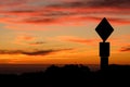 Road sign silhouette and colorful sunset Royalty Free Stock Photo