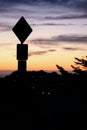 Road sign silhouette and colorful sunset Royalty Free Stock Photo