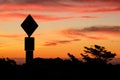 Road sign silhouette and colorful sunset Royalty Free Stock Photo